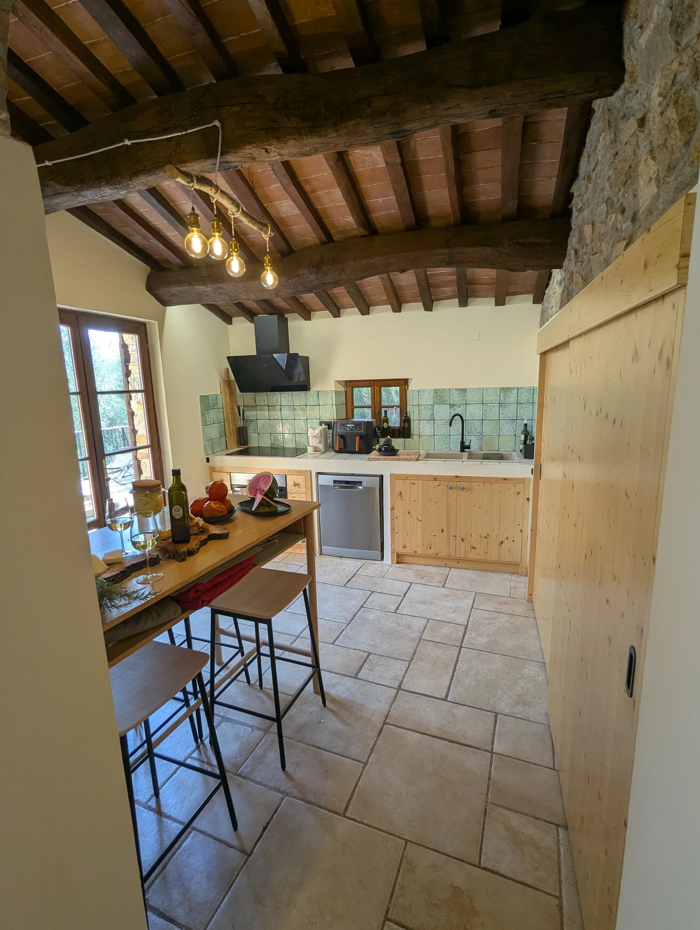 Kitchen island with wine and fresh produce, beside the breakfast bar