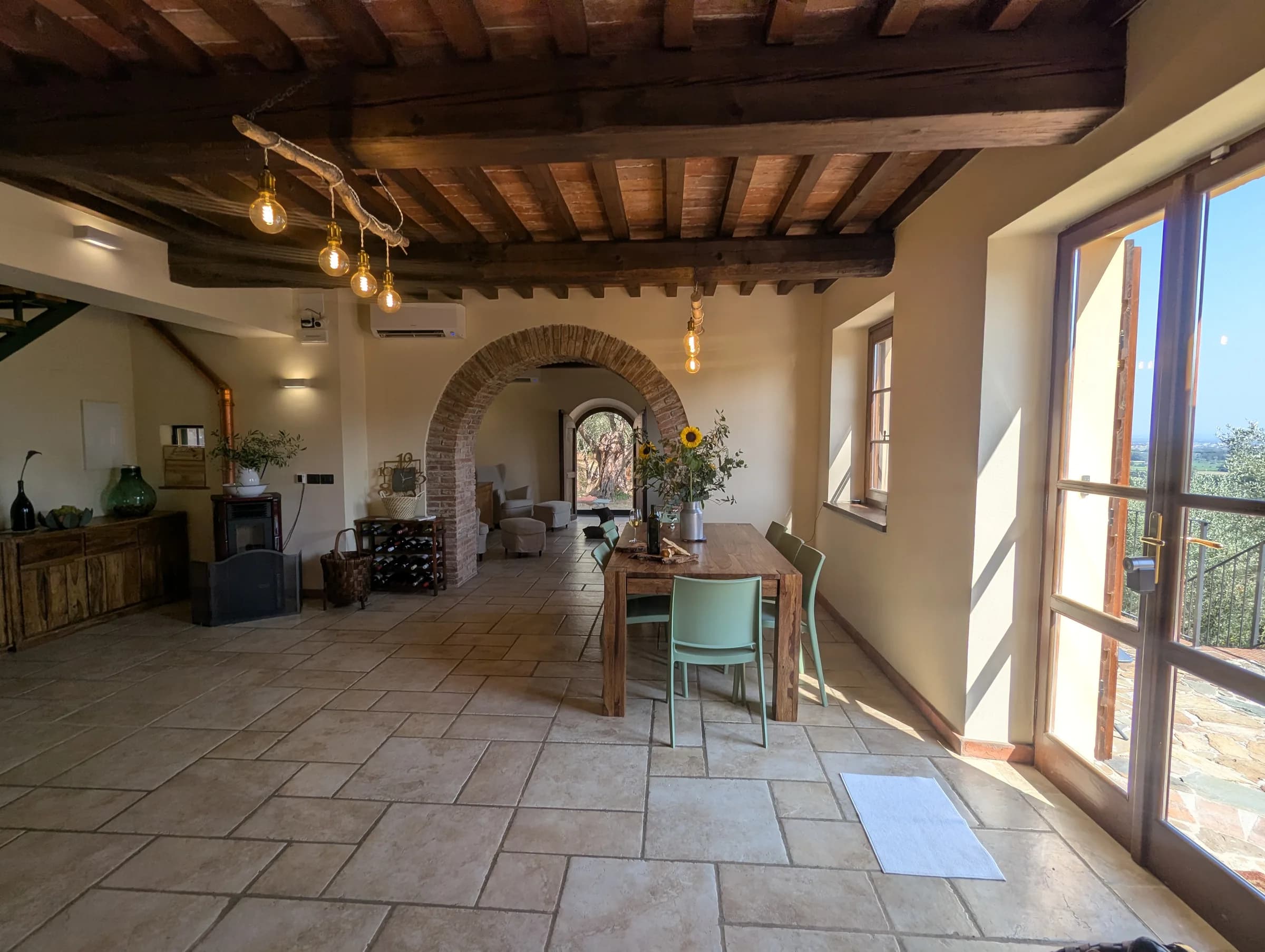 The open-plan living and dining hall, with brick archways and valley views
